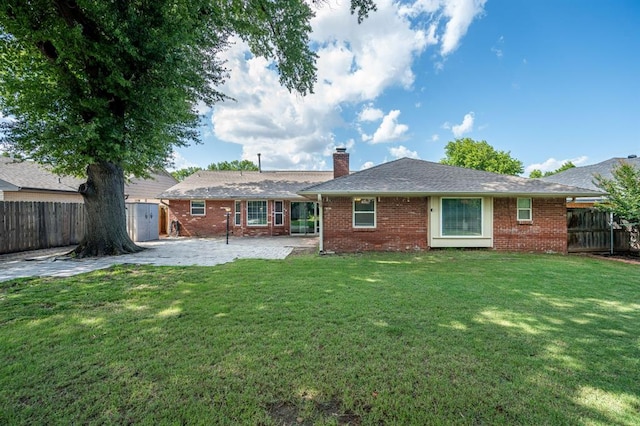 2504 NW 119th St, Oklahoma City, OK 73120 - back of property with a fenced backyard, a patio, a storage unit, a chimney, and brick siding