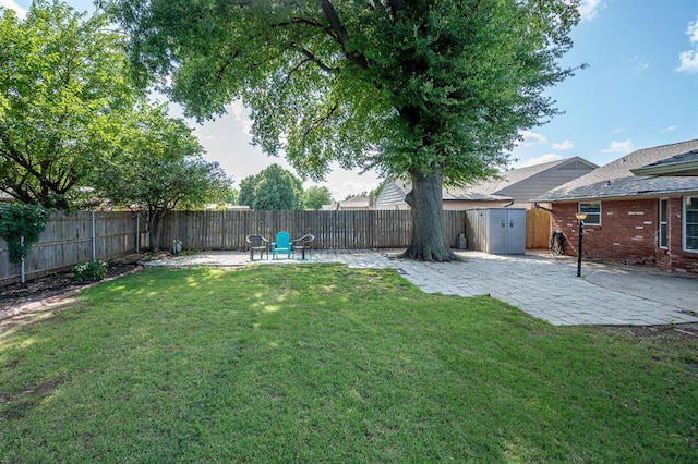 2504 NW 119th St, Oklahoma City, OK 73120 - fenced backyard with a patio area and a storage unit