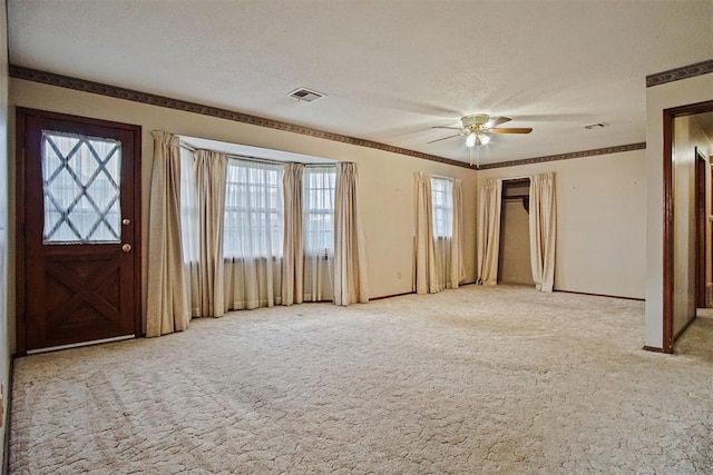 3913 SE 14th Pl, Oklahoma City, OK 73115 - entryway with carpet flooring, ceiling fan, and a textured ceiling