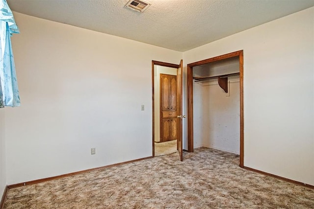 3913 SE 14th Pl, Oklahoma City, OK 73115 - unfurnished bedroom with carpet floors, a closet, and a textured ceiling