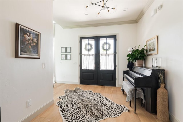 501 Old Creek Rd, Edmond, OK 73034 - foyer with french doors, a chandelier, light wood-type flooring, and ornamental molding