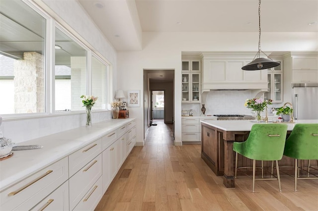 501 Old Creek Rd, Edmond, OK 73034 - kitchen featuring stainless steel appliances, light wood-type flooring, light countertops, and tasteful backsplash