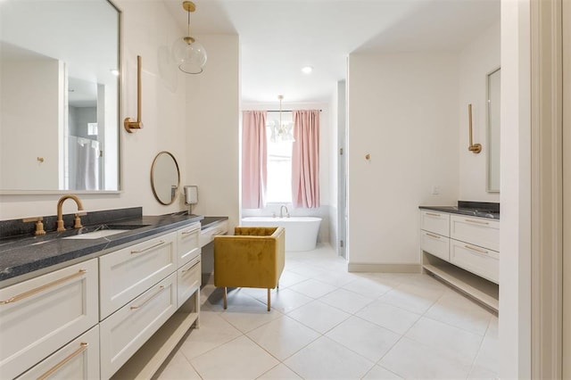 501 Old Creek Rd, Edmond, OK 73034 - full bathroom with two vanities, a freestanding tub, and tile patterned flooring