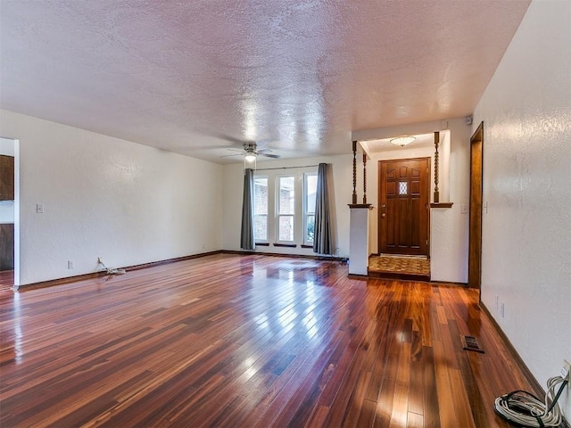 2912 Smiling Hill Blvd, Edmond, OK 73013 - unfurnished living room with hardwood / wood-style flooring, ceiling fan, and a textured ceiling