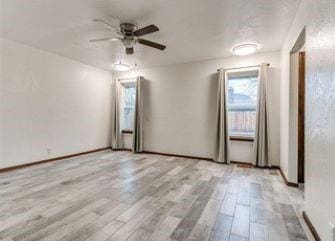 2912 Smiling Hill Blvd, Edmond, OK 73013 - empty room featuring healthy amount of natural light, ceiling fan, and wood finished floors