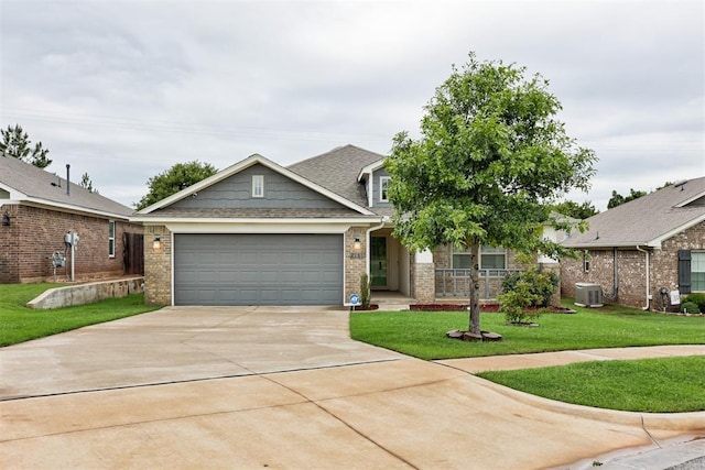 2161 Native Dancer Dr, Choctaw, OK 73020 - view of front facade featuring driveway, an attached garage, a front yard, brick siding, and roof with shingles
