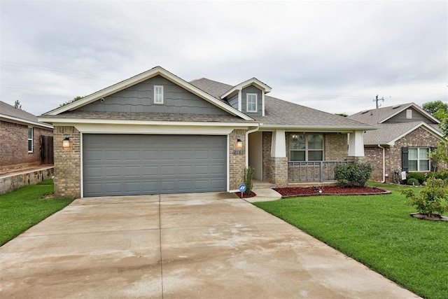 2161 Native Dancer Dr, Choctaw, OK 73020 - craftsman-style home with a porch, driveway, a front yard, brick siding, and a garage