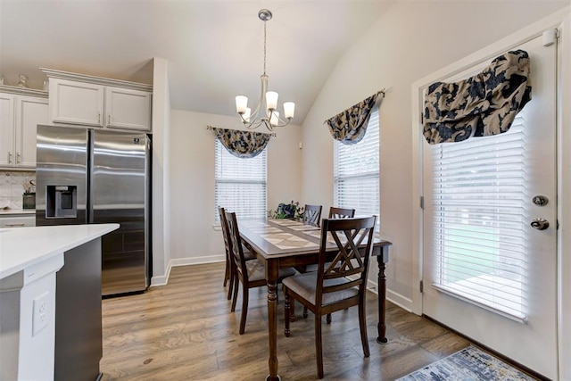 2161 Native Dancer Dr, Choctaw, OK 73020 - dining area with a chandelier, vaulted ceiling, and light wood-type flooring
