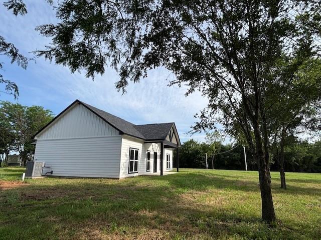 379100 E 1100th Rd, Okemah, OK 74859 - view of property exterior featuring a yard and board and batten siding