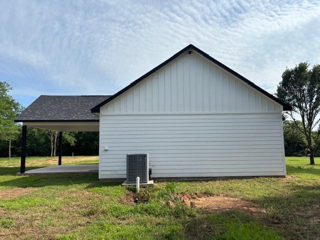 379100 E 1100th Rd, Okemah, OK 74859 - view of home's exterior with a yard and board and batten siding