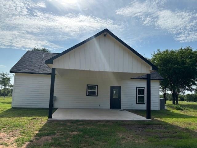 379100 E 1100th Rd, Okemah, OK 74859 - back of property with a patio area, board and batten siding, a yard, and a shingled roof