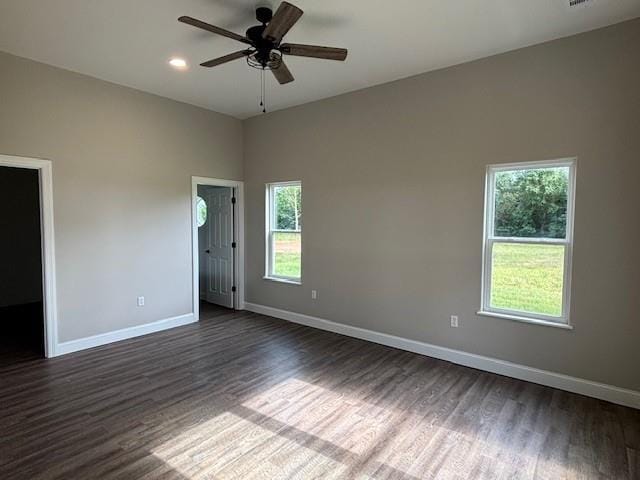 379100 E 1100th Rd, Okemah, OK 74859 - empty room with dark wood-style floors, healthy amount of natural light, ceiling fan, and recessed lighting