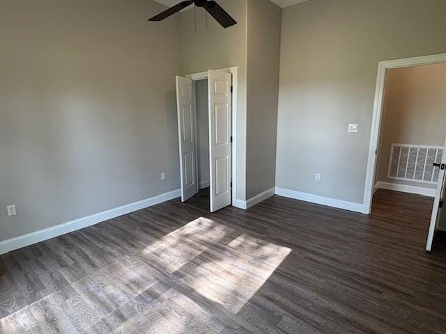379100 E 1100th Rd, Okemah, OK 74859 - unfurnished bedroom with dark wood finished floors, high vaulted ceiling, and ceiling fan