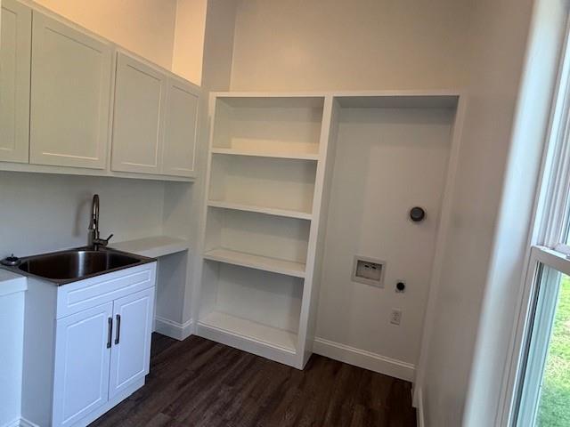 379100 E 1100th Rd, Okemah, OK 74859 - washroom with dark wood-style floors, electric dryer hookup, and cabinet space