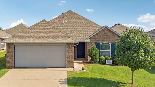4116 NW 154th St, Edmond, OK 73013 - view of front of home featuring roof with shingles, brick siding, a garage, concrete driveway, and a front lawn