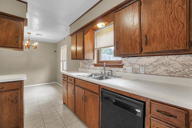 908 S Trail Dr, Altus, OK 73521 - kitchen with dishwasher, brown cabinetry, light countertops, light tile patterned floors, and a chandelier