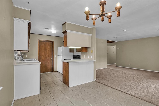 908 S Trail Dr, Altus, OK 73521 - kitchen featuring a chandelier, freestanding refrigerator, light countertops, range, and light tile patterned flooring