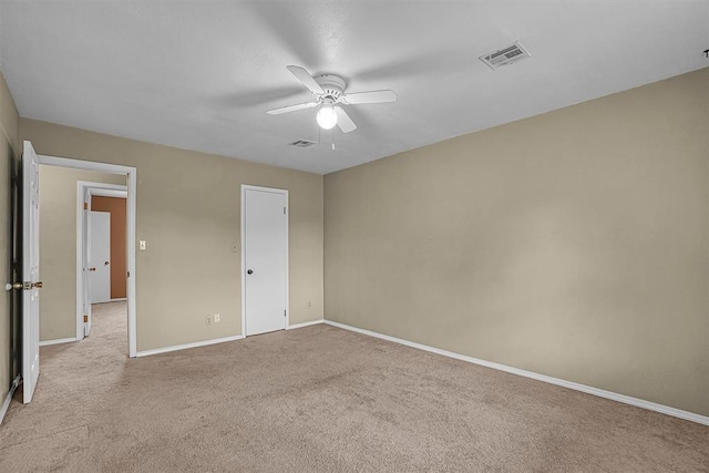 908 S Trail Dr, Altus, OK 73521 - unfurnished bedroom with light carpet and ceiling fan