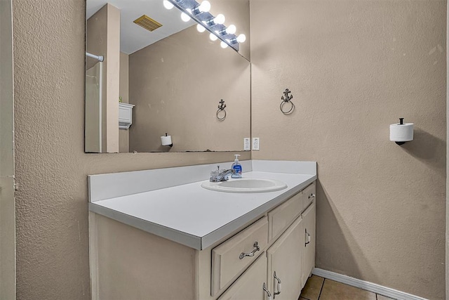 908 S Trail Dr, Altus, OK 73521 - bathroom with vanity, tile patterned flooring, and a textured wall