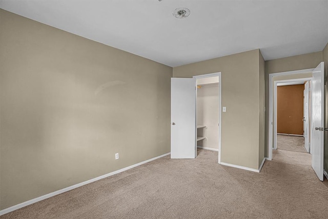 908 S Trail Dr, Altus, OK 73521 - unfurnished bedroom featuring carpet floors, a spacious closet, and a closet