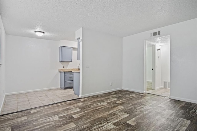 6220 S Douglas Ave, Oklahoma City, OK 73139 - spare room featuring wood finished floors and a textured ceiling