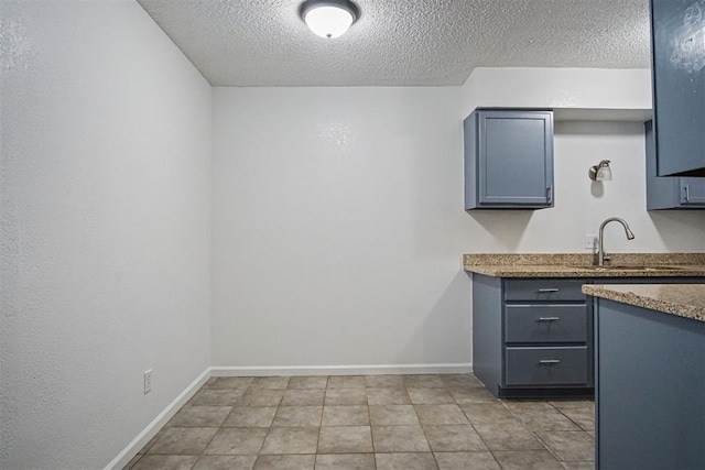 6220 S Douglas Ave, Oklahoma City, OK 73139 - kitchen featuring a textured ceiling and light tile patterned flooring