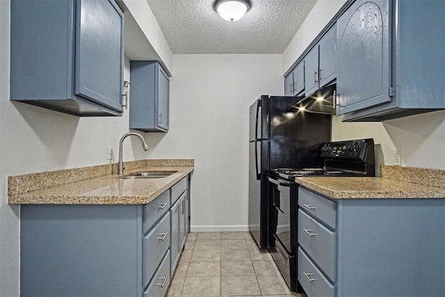 6220 S Douglas Ave, Oklahoma City, OK 73139 - kitchen featuring black range with electric cooktop, a textured ceiling, light tile patterned floors, and blue cabinets