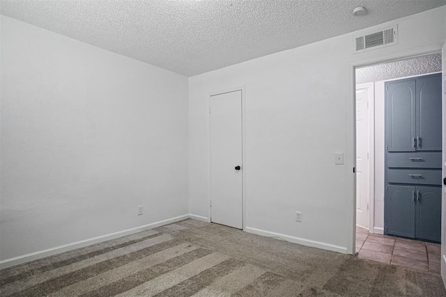 6220 S Douglas Ave, Oklahoma City, OK 73139 - carpeted empty room featuring a textured ceiling and baseboards