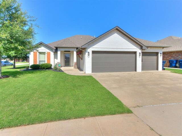 7313 Jack Dr, Oklahoma City, OK 73132 - ranch-style home featuring a garage, concrete driveway, a front lawn, and brick siding