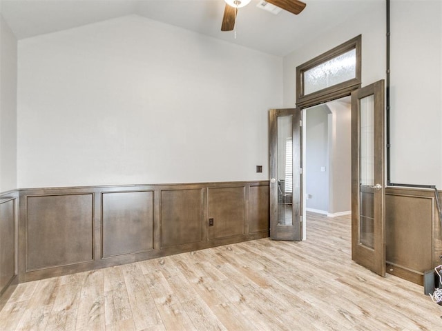 7313 Jack Dr, Oklahoma City, OK 73132 - unfurnished room featuring ceiling fan, french doors, a wainscoted wall, light wood-style flooring, and lofted ceiling