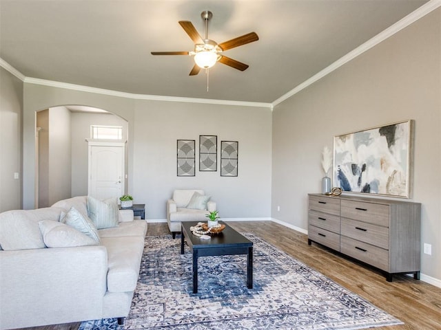 7313 Jack Dr, Oklahoma City, OK 73132 - living room with arched walkways, wood finished floors, crown molding, and a ceiling fan