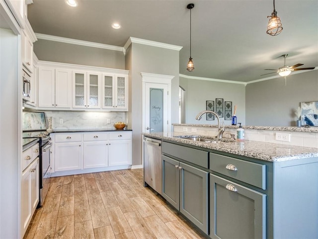 7313 Jack Dr, Oklahoma City, OK 73132 - kitchen featuring stainless steel appliances, crown molding, white cabinets, ceiling fan, and decorative light fixtures
