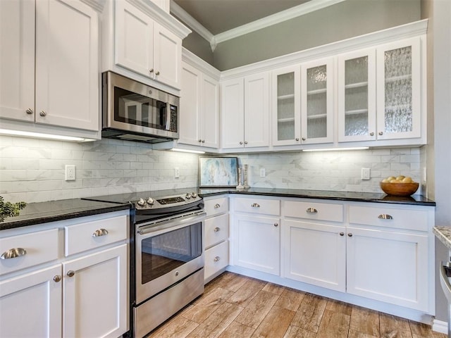 7313 Jack Dr, Oklahoma City, OK 73132 - kitchen with stainless steel appliances, ornamental molding, white cabinets, glass insert cabinets, and tasteful backsplash