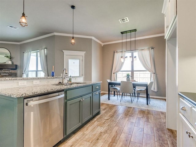7313 Jack Dr, Oklahoma City, OK 73132 - kitchen featuring stainless steel dishwasher, light wood-style floors, crown molding, decorative light fixtures, and light stone counters