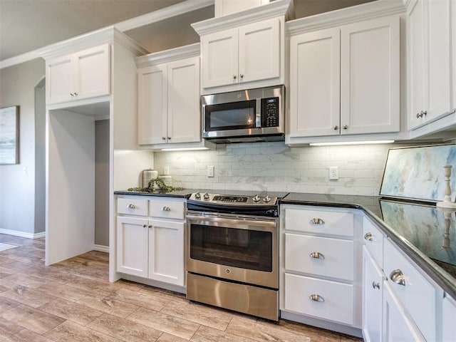 7313 Jack Dr, Oklahoma City, OK 73132 - kitchen with stainless steel appliances, dark countertops, tasteful backsplash, and white cabinetry