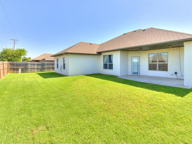 7313 Jack Dr, Oklahoma City, OK 73132 - back of house with a fenced backyard, roof with shingles, a patio, and brick siding