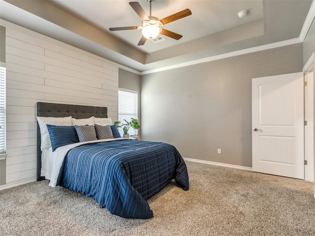 7313 Jack Dr, Oklahoma City, OK 73132 - bedroom featuring a raised ceiling, carpet flooring, a ceiling fan, and crown molding