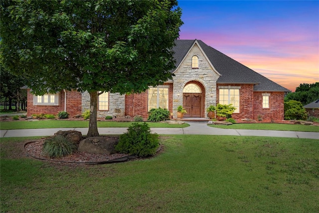 227 Quail Hollow Way, Choctaw, OK 73020 - view of front of house with a lawn, roof with shingles, and stone siding