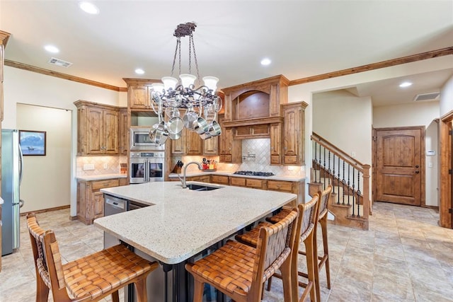 227 Quail Hollow Way, Choctaw, OK 73020 - kitchen with appliances with stainless steel finishes, a chandelier, ornamental molding, decorative backsplash, and a kitchen island with sink