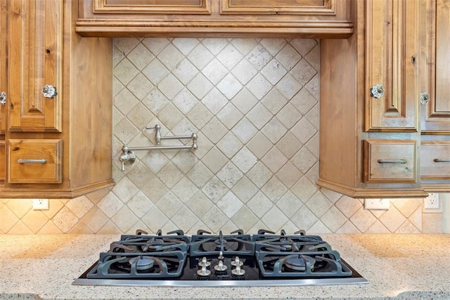 227 Quail Hollow Way, Choctaw, OK 73020 - kitchen featuring gas stovetop, light stone countertops, and backsplash