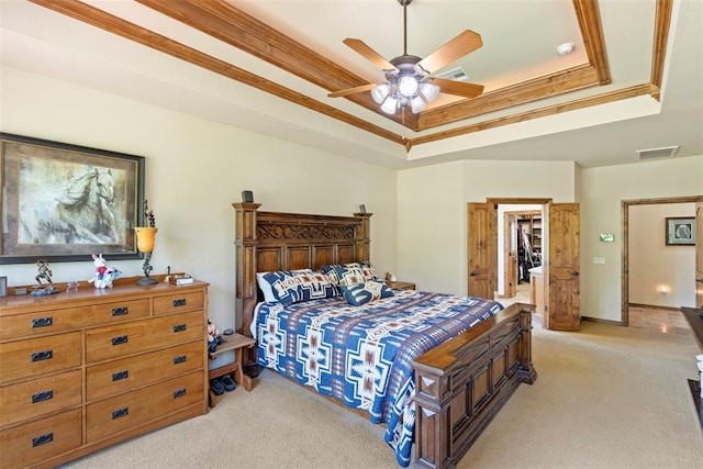 227 Quail Hollow Way, Choctaw, OK 73020 - bedroom with a tray ceiling, light carpet, a walk in closet, ornamental molding, and ceiling fan