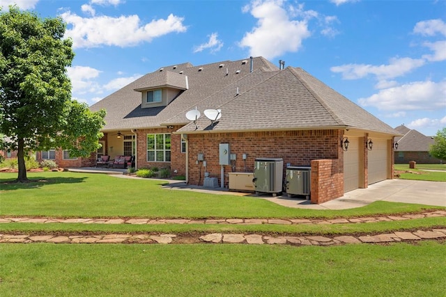 227 Quail Hollow Way, Choctaw, OK 73020 - back of property featuring brick siding, a yard, concrete driveway, and a shingled roof