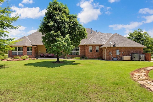 227 Quail Hollow Way, Choctaw, OK 73020 - back of house featuring brick siding, a lawn, a patio area, and a shingled roof