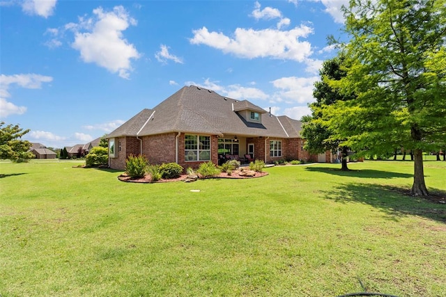 227 Quail Hollow Way, Choctaw, OK 73020 - rear view of house featuring brick siding, a yard, and a shingled roof