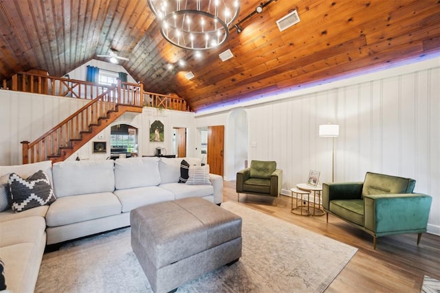 80 E Shore Dr, Arcadia, OK 73007 - living area with arched walkways, a chandelier, wood finished floors, vaulted ceiling, and stairway