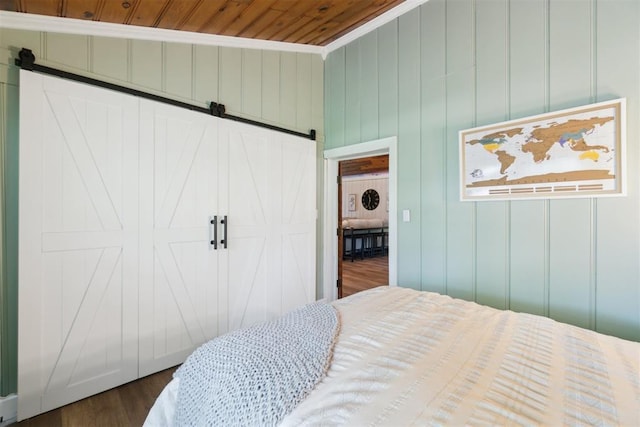 80 E Shore Dr, Arcadia, OK 73007 - bedroom with a barn door, wooden ceiling, and dark wood-type flooring