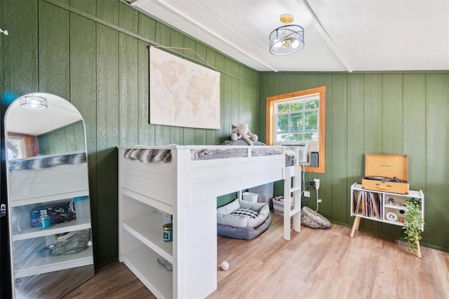 80 E Shore Dr, Arcadia, OK 73007 - bedroom with wood finished floors, cooling unit, and wooden walls