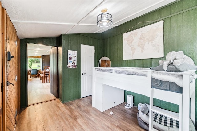 80 E Shore Dr, Arcadia, OK 73007 - bedroom with light wood-style floors, wooden walls, and vaulted ceiling