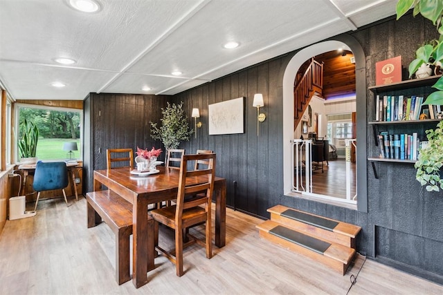 80 E Shore Dr, Arcadia, OK 73007 - dining area featuring arched walkways, light wood-style floors, recessed lighting, and wooden walls