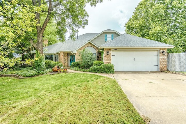 1209 Fox Bluff Ct, Edmond, OK 73034 - view of front of house with a garage, concrete driveway, brick siding, and roof with shingles